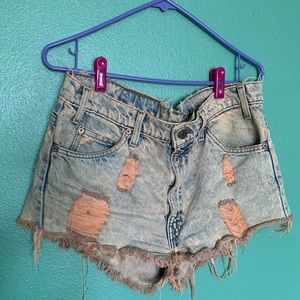 Levi’s 505 cut off shorts in a pink wash.